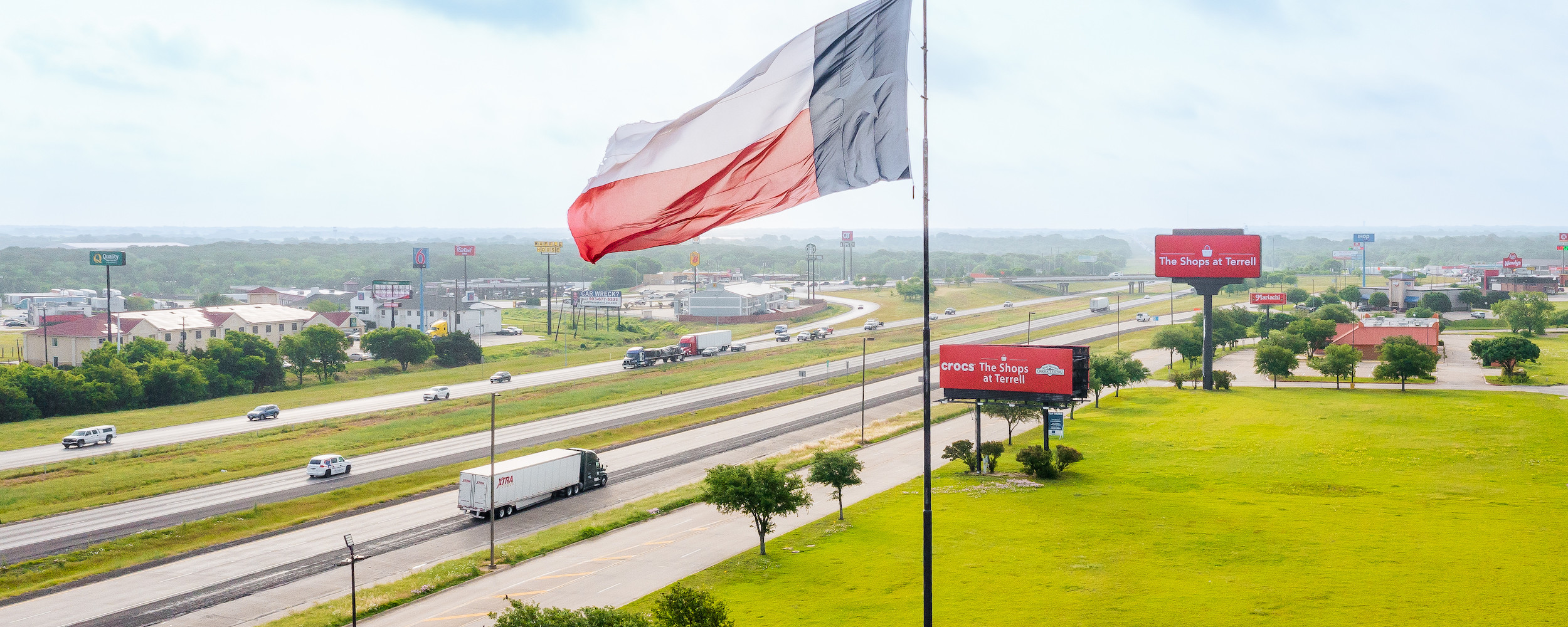 Aerial view of Shops at Terrell sign with Texas flag